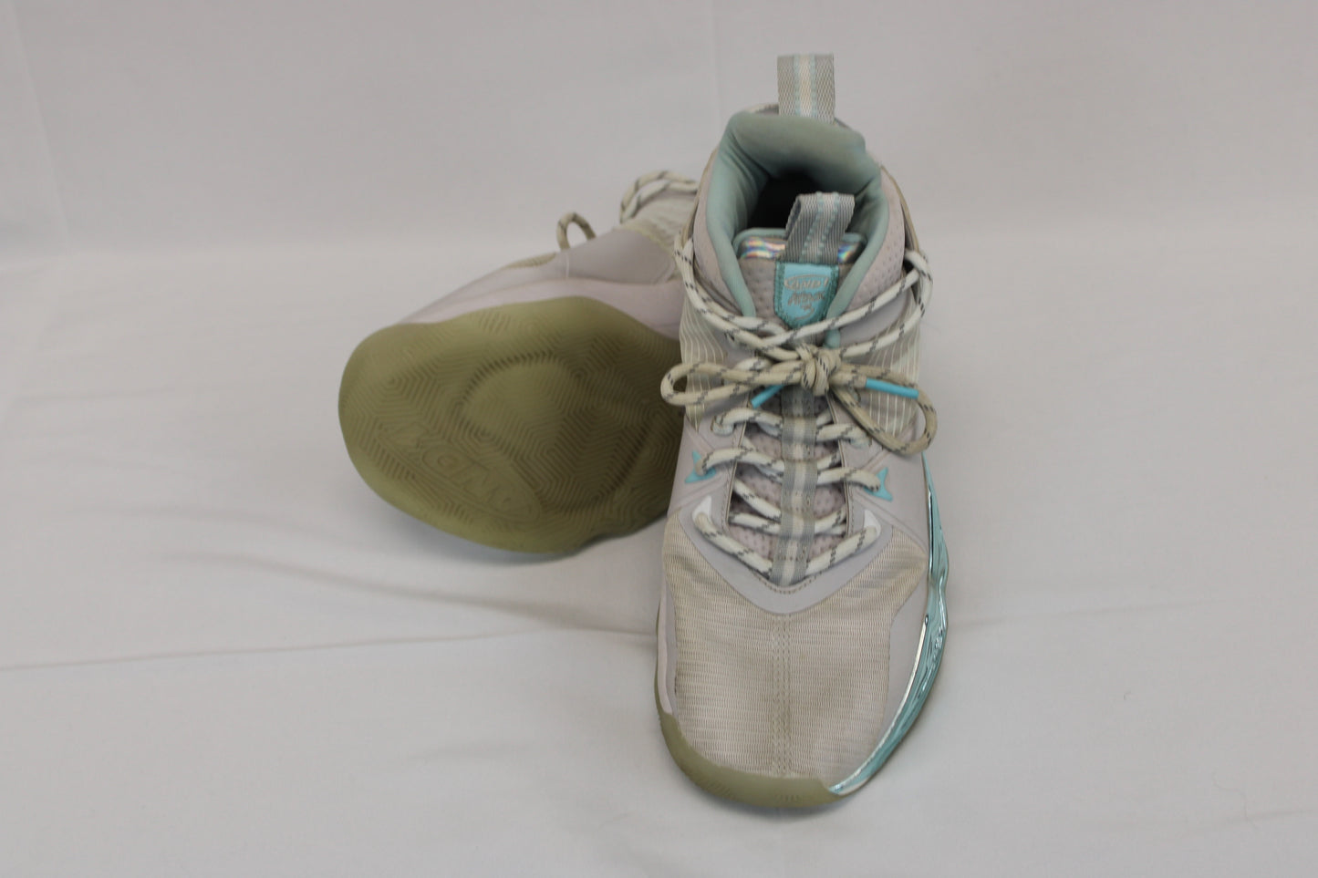 And 1 low top basketball shoe, white/teal metallic, Youth 7