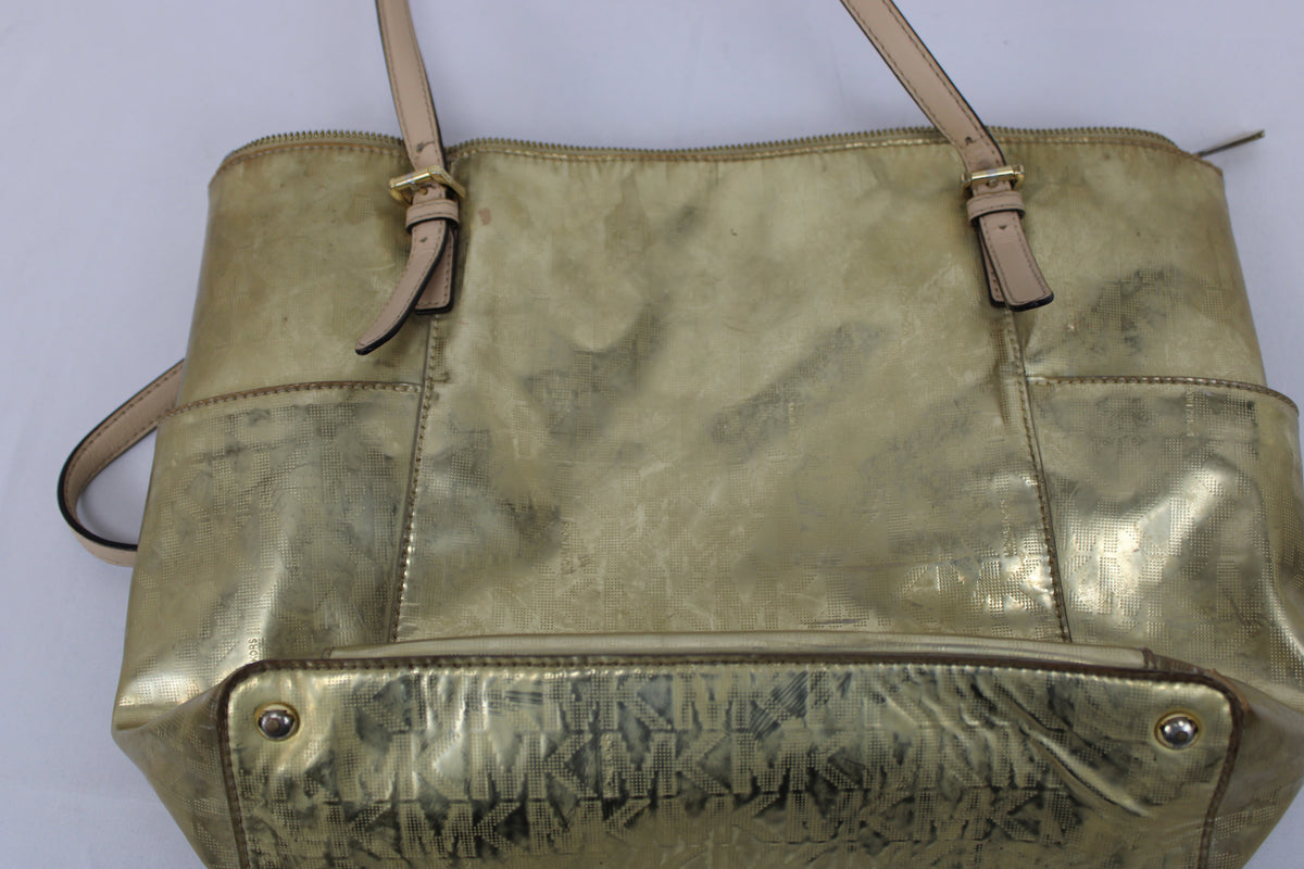 Michael Kors metallic gold tote bag with top zip and exterior pockets, heavy wear