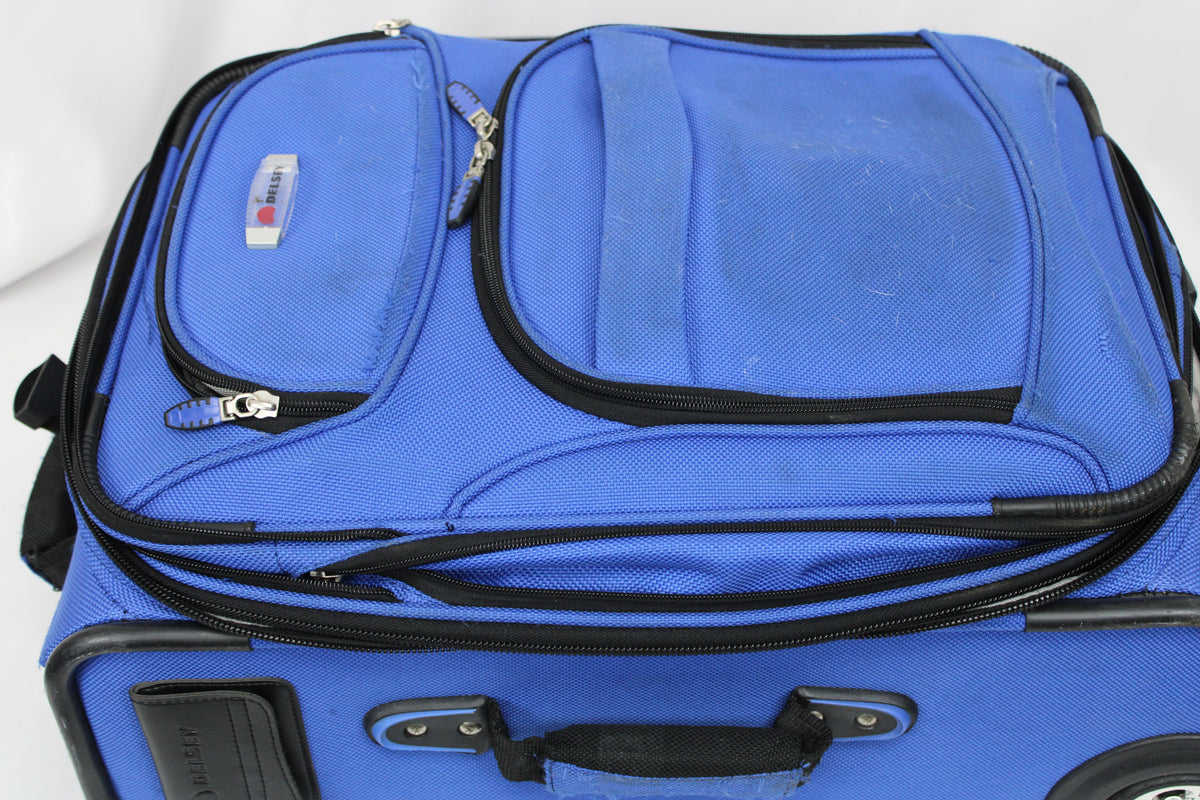 Delsey carry on sized suitcase with three external pockets, royal blue